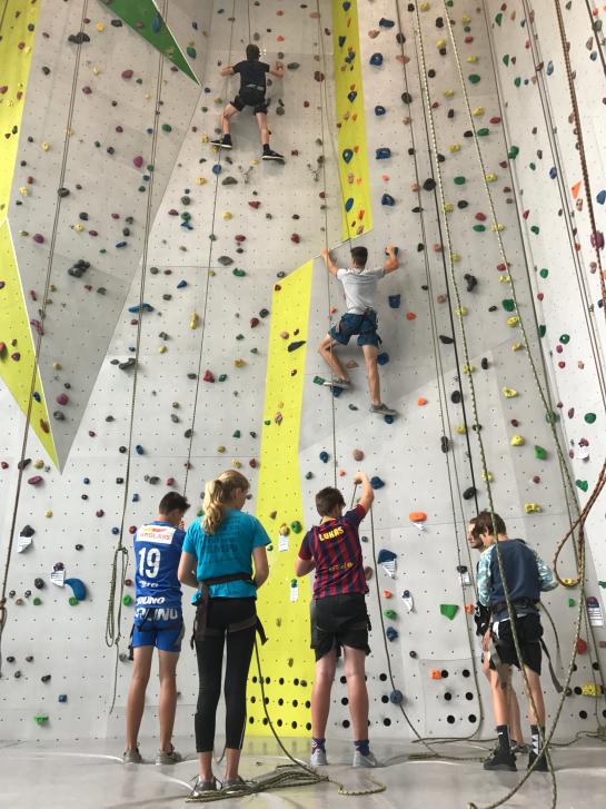 Groep jongeren op de klimmuur.